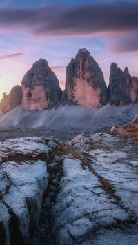 The mountain trail and high rocks at colorful sunset