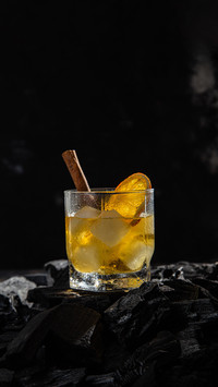 Cocktail with whiskey and ice on a dark background