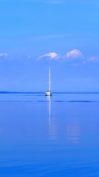 Sailing yacht on wavy lake surface