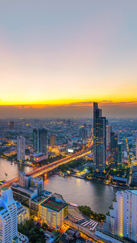 Bangkok's modern business buildings stand along the river