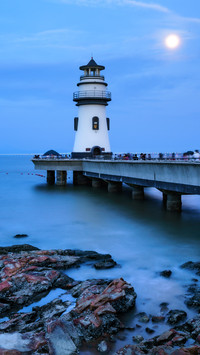 The beach lighthouse and the moon