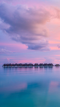 Sunset on Maldives island, water villas resort