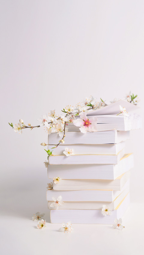 Stack of Books with Spring Flowers between Pages preview