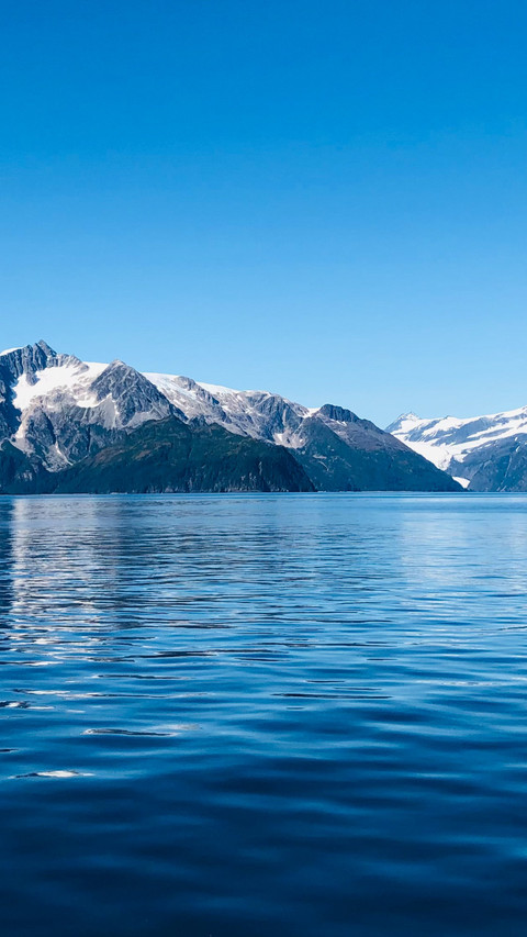 The sky is clear and blue and the mountains reflect the preview