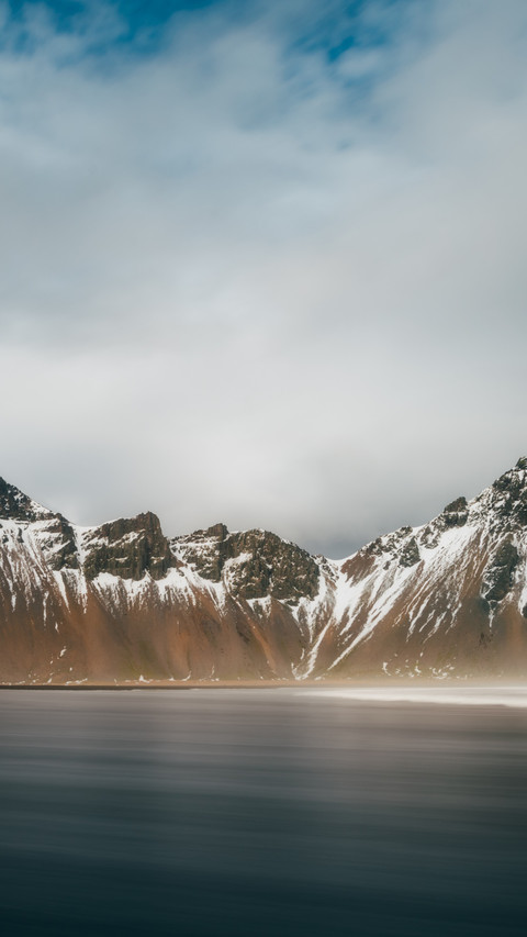 The snow-capped mountain reflects the cold sky preview