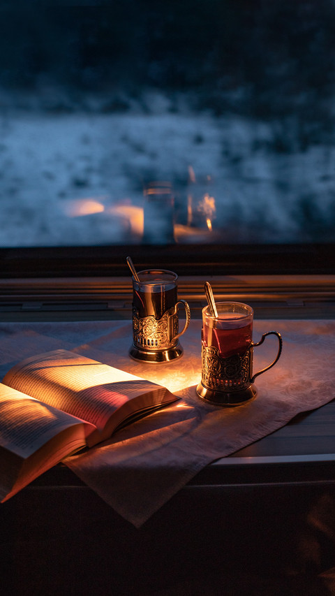 Cups of tea on the table in the train. Window. Evening preview