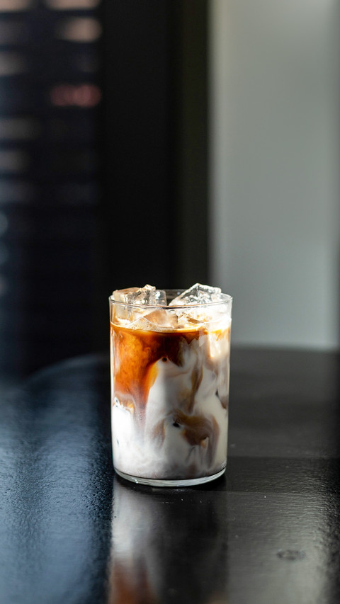 Iced coffee in glass on table in coffee shop blur background preview