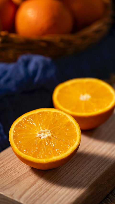 There is a sliced orange on the wooden table preview