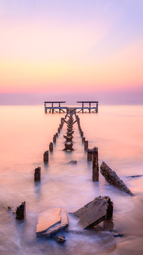 The old pier is in a decayed condition in the morning light preview