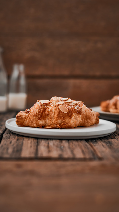 Almond croissant with custard filling on wood background preview