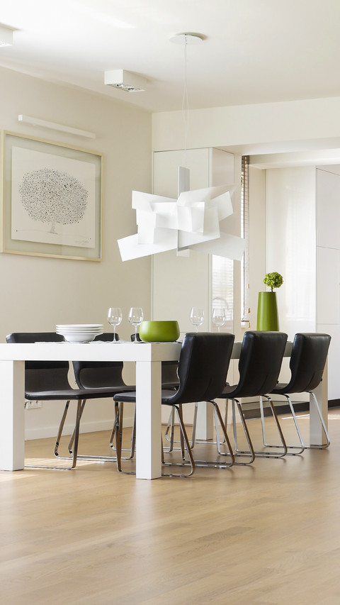 White dining table and black upholstered chairs in modern preview