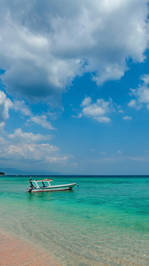 Blue sea, blue sky, sandy beach, fishing boat preview