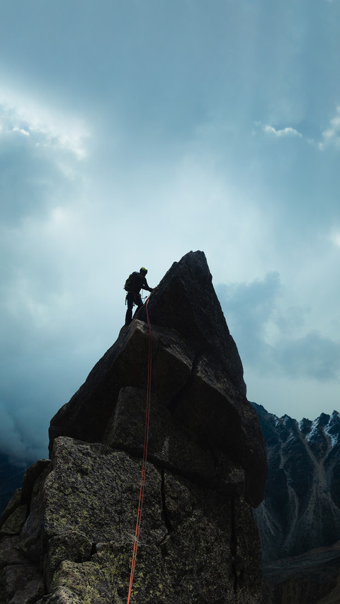 Man climber looking for adventure on top of the mountain preview