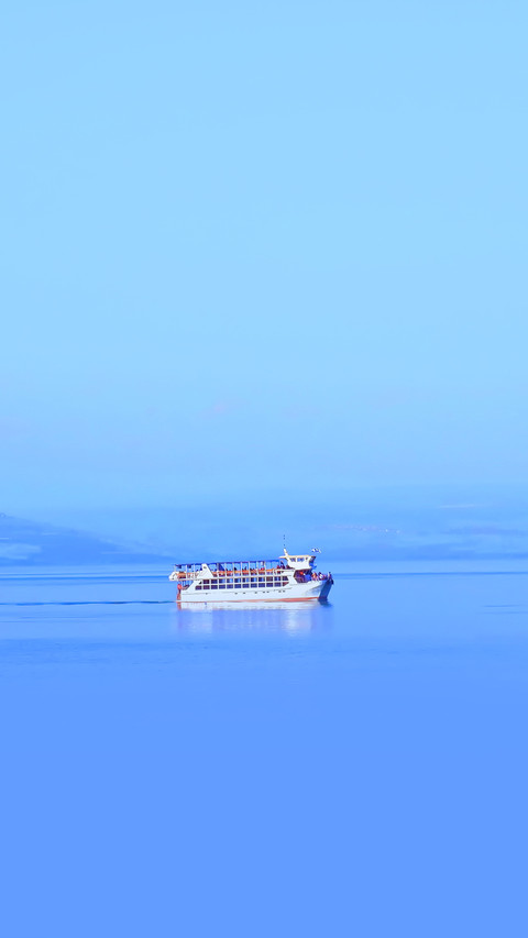Cruise boat in middle of blue flat lake preview