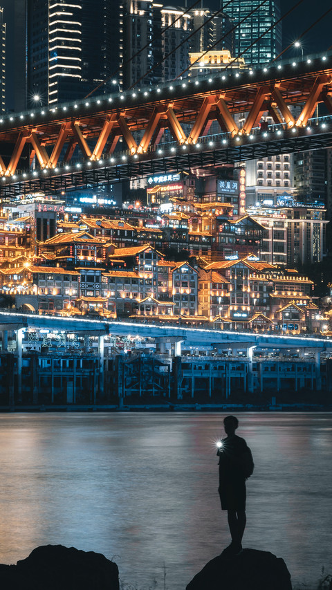 Man Standing by The River Under The Bridge at Night preview
