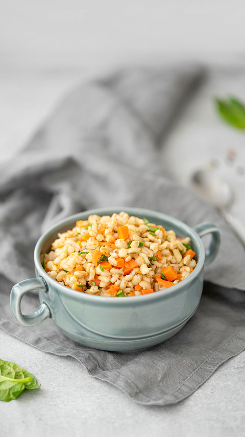 Boiled barley porridge with vegetables and spices in a plate preview