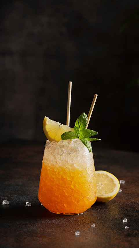 Cocktail with crushed ice, lemon and mint on dark background preview