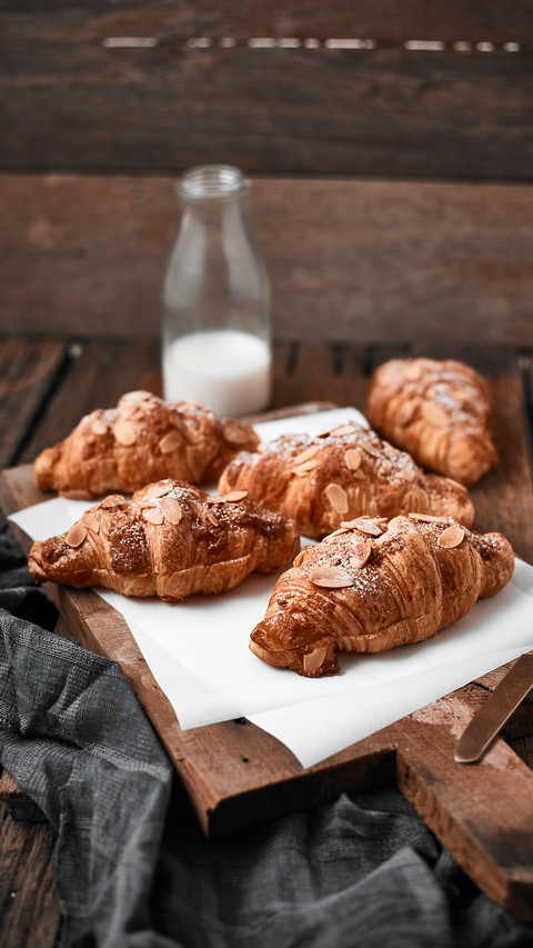 Almond croissant with custard filling on wood background preview