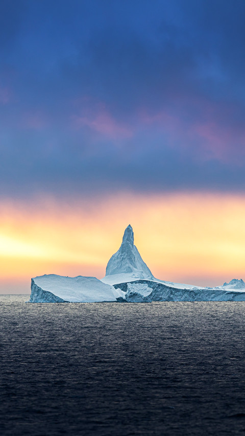 Iceberg ice formation in front of midnight sun in Antarctica preview