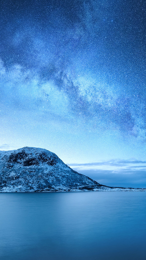 Galaxy above the mountains and the ocean. Landscape at night preview