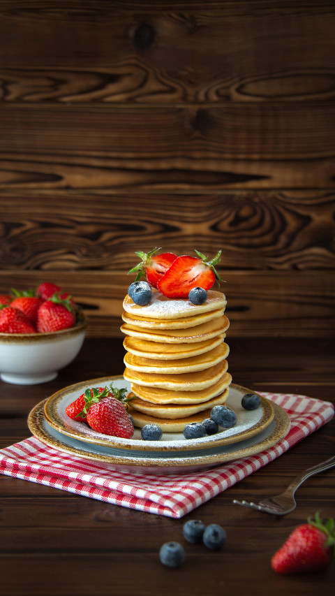 Blueberries and jars of berries on wooden background preview