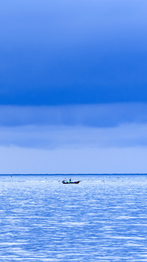 Floating fishing boats aground at the harbor over cloudy sky preview