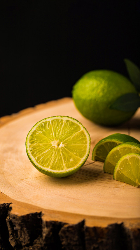 Fresh ripe limes on wooden background preview