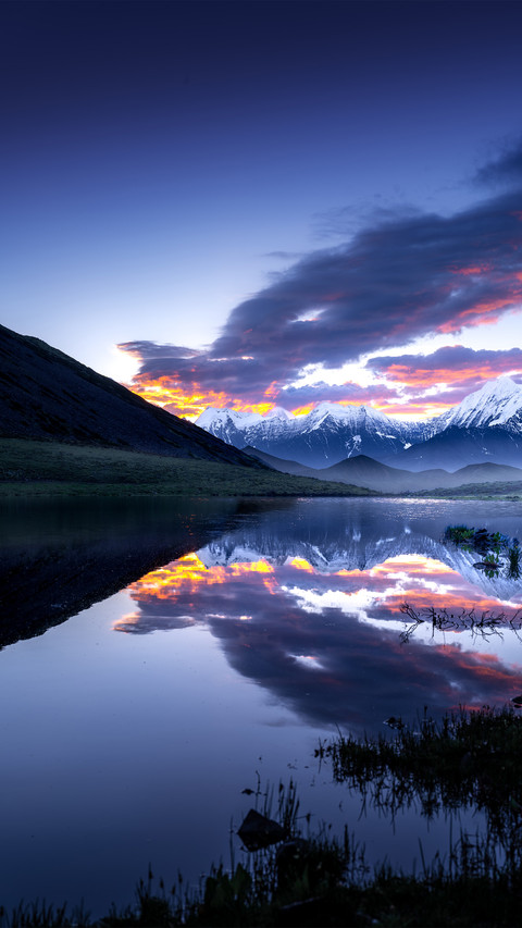 The snowcapped mountains reflect the morning glow preview