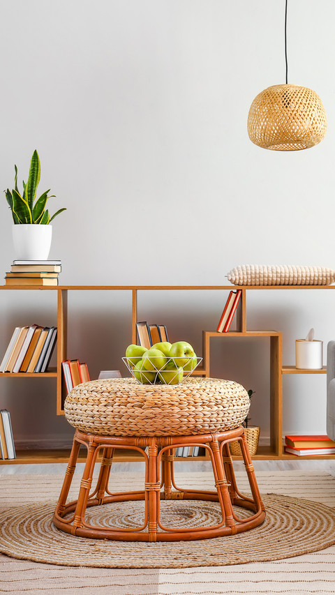 Basket with green apples on wicker table in stylish room preview