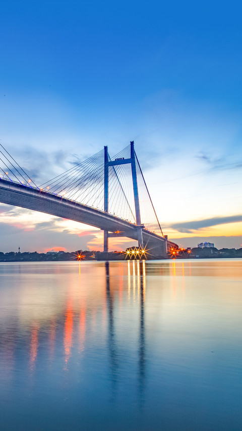 A  bridge on river Hooghly at dusk with city light preview