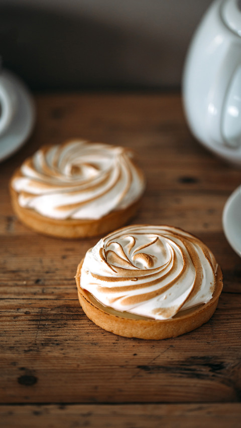 Tartlet with lemon cream and meringue on wooden background preview
