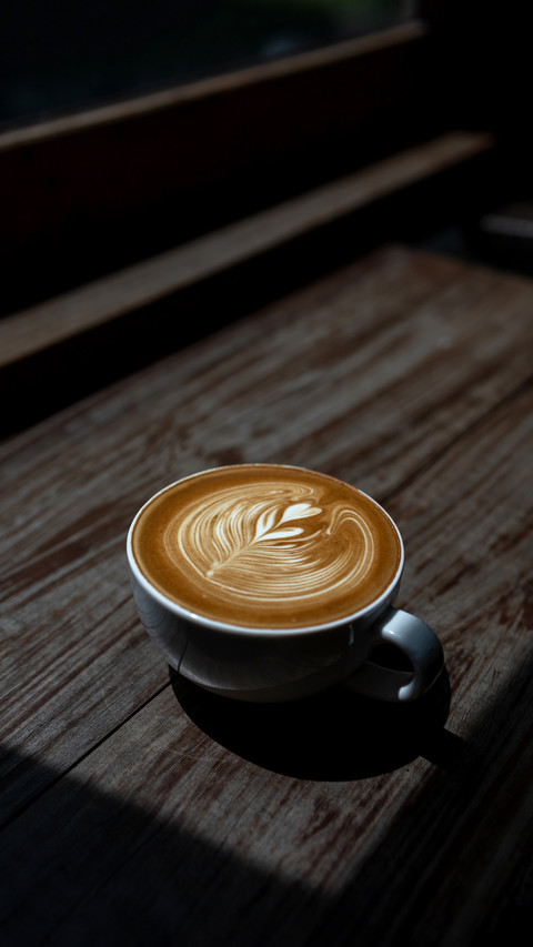 Coffee latte art on wooden bar background preview