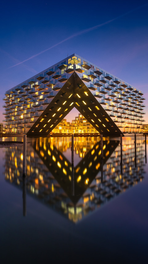 Modern Architecture Mirrors Sky and Water in Deep Blue Hour preview