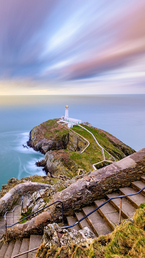 Stairs to lighthouse overlooking sea sunrise preview