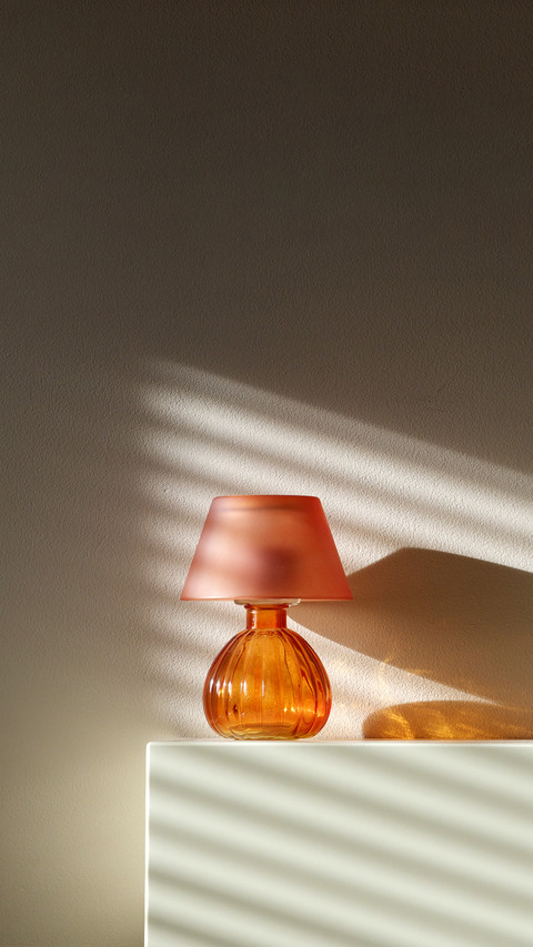 Lamp on fireplace with wall shadows from window preview