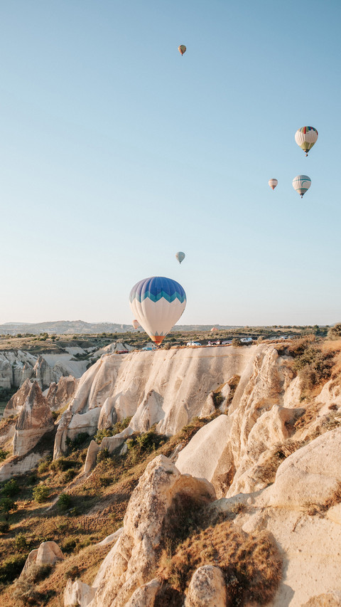 Hot air balloon against Cappadocia's rocks in Turkey preview