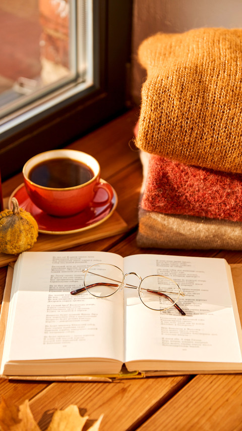 Open book with glasses, cup of coffee, autumn wool sweaters preview