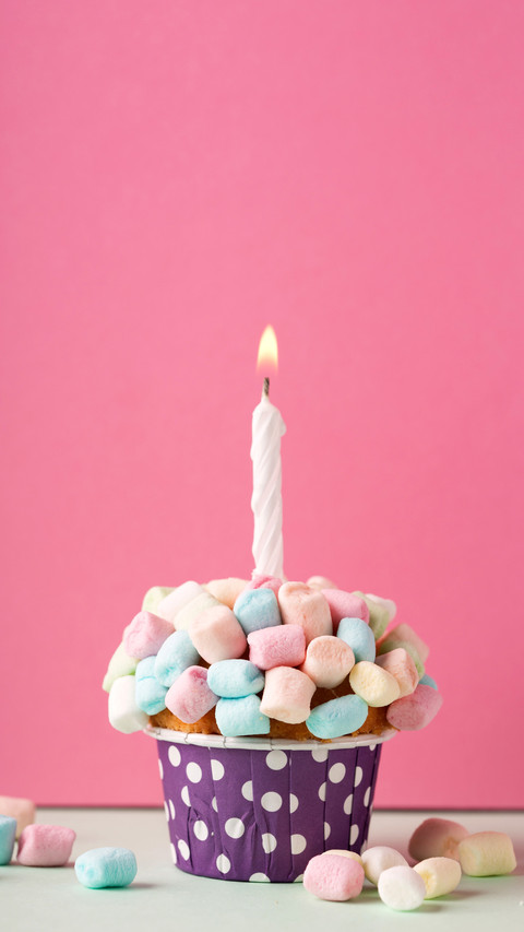 Birthday vanilla cupcake with colorful marshmallows preview