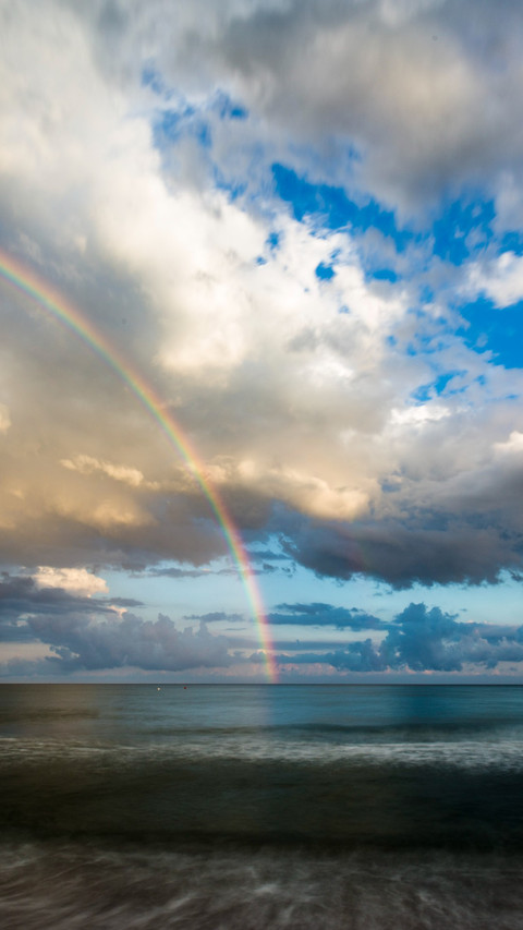 Rainbow spans the sky, beauty reflected preview