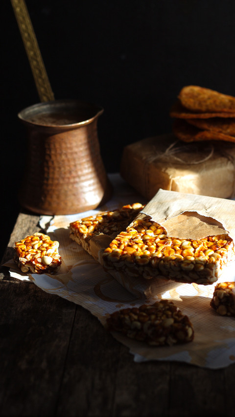 Peanut brittle on a wooden table in a rustic dark background preview