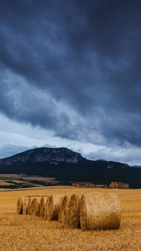 Straw bales in the field at sunset with dramatic sky preview