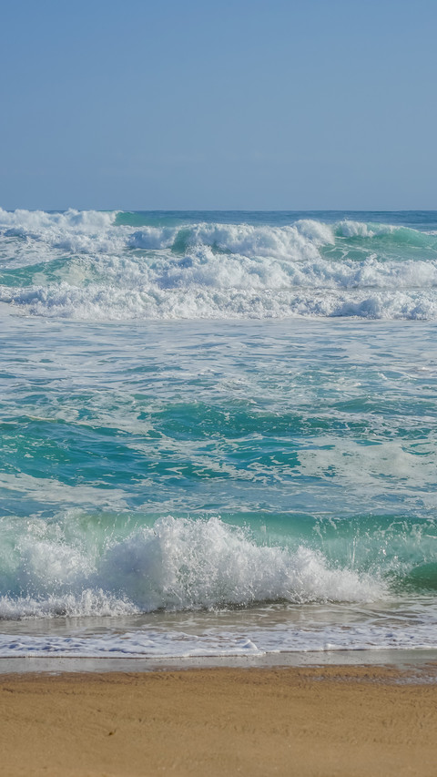 The waves crash against the beach preview
