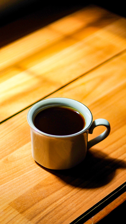 Black coffee in a white cup on a wooden table preview