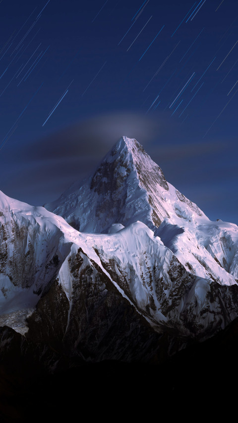 A solitary peak stands still in the clouds preview