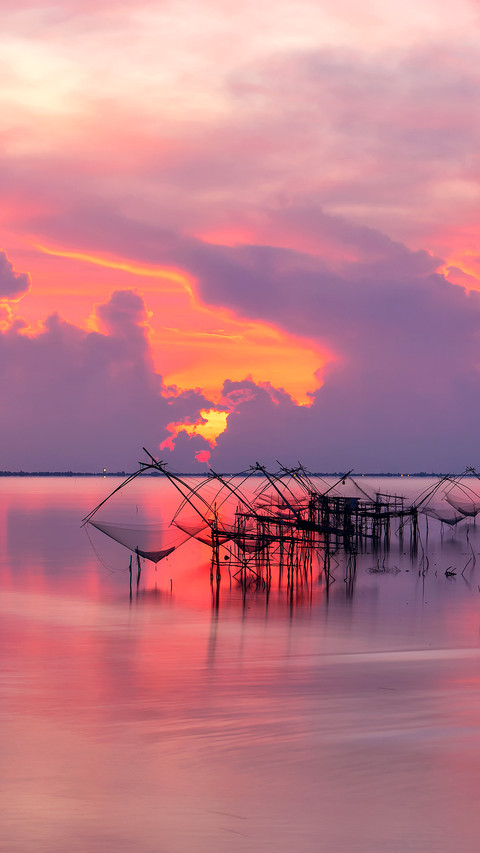 Local fishing nets in a lake with fisherman in sunrise preview