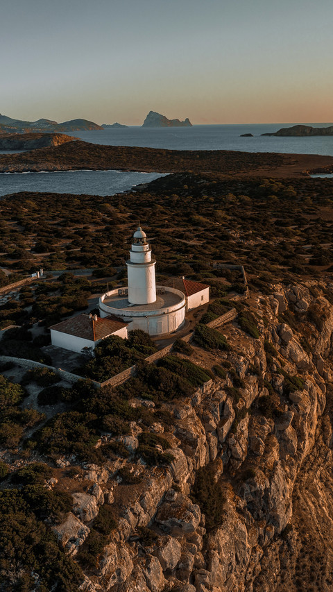 Lighthouse at sunset on cliff overlooking Mediterranean preview