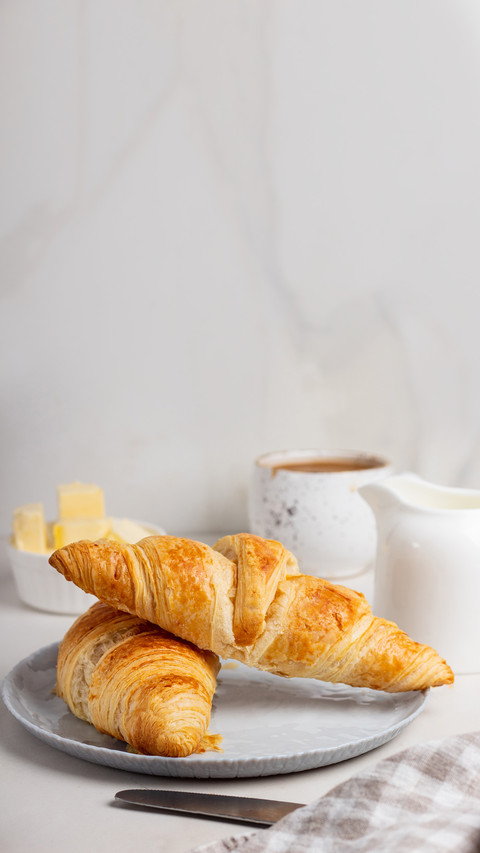 Fresh french croissants on plate and cup of coffee preview