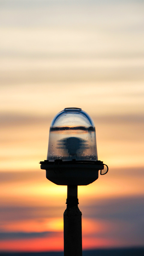 Warning light on a sunset background preview