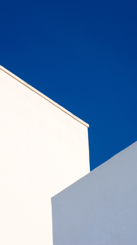 Two buildings reflecting the blue sky preview