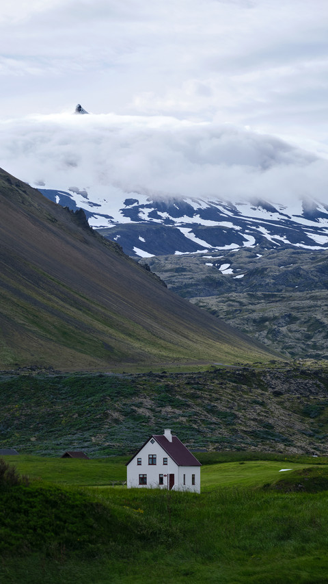 A picturesque scene in Iceland featuring a white house preview